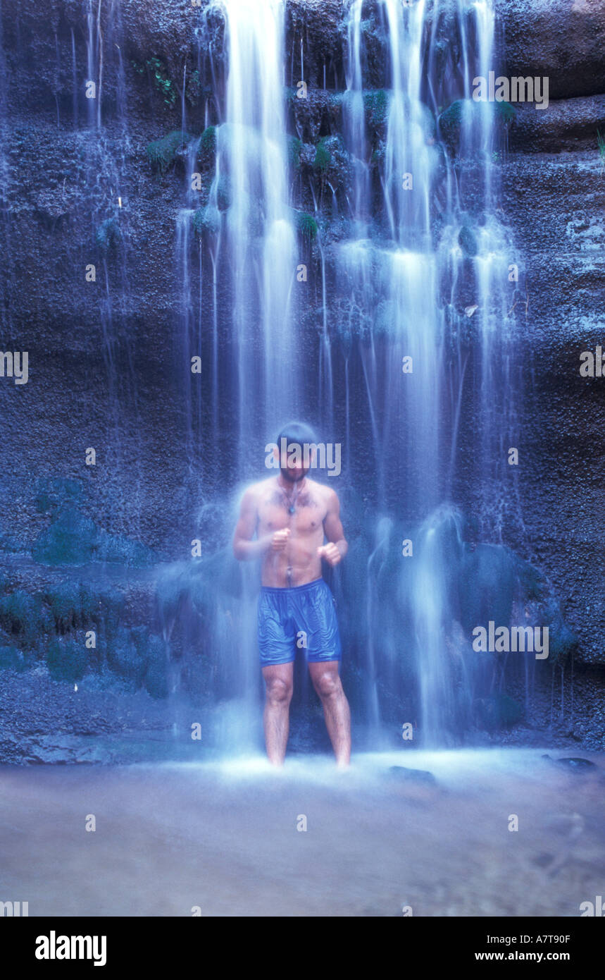 Man Standing Under a Waterfall Stock Photo Alamy