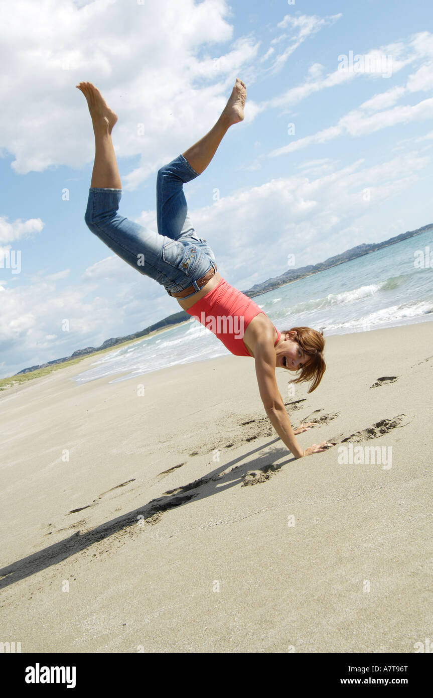 Beach Rode Side Profile Side profile of woman doing cartwheel on beach Stock Photo - Alamy