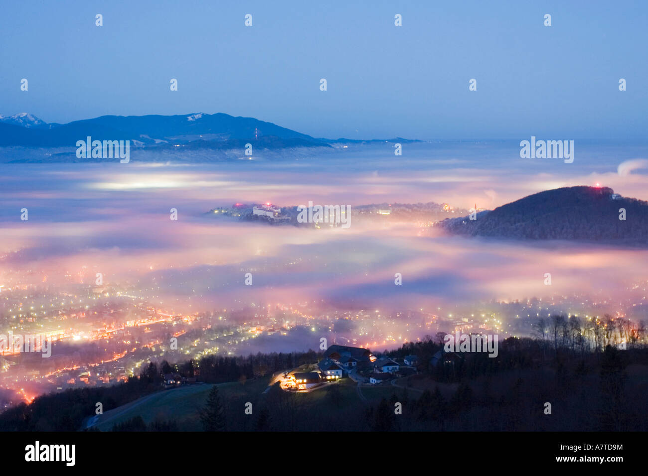 Aerial view of city lit up at dawn, Mt Gaisberg, Salzburg, Austria Stock Photo