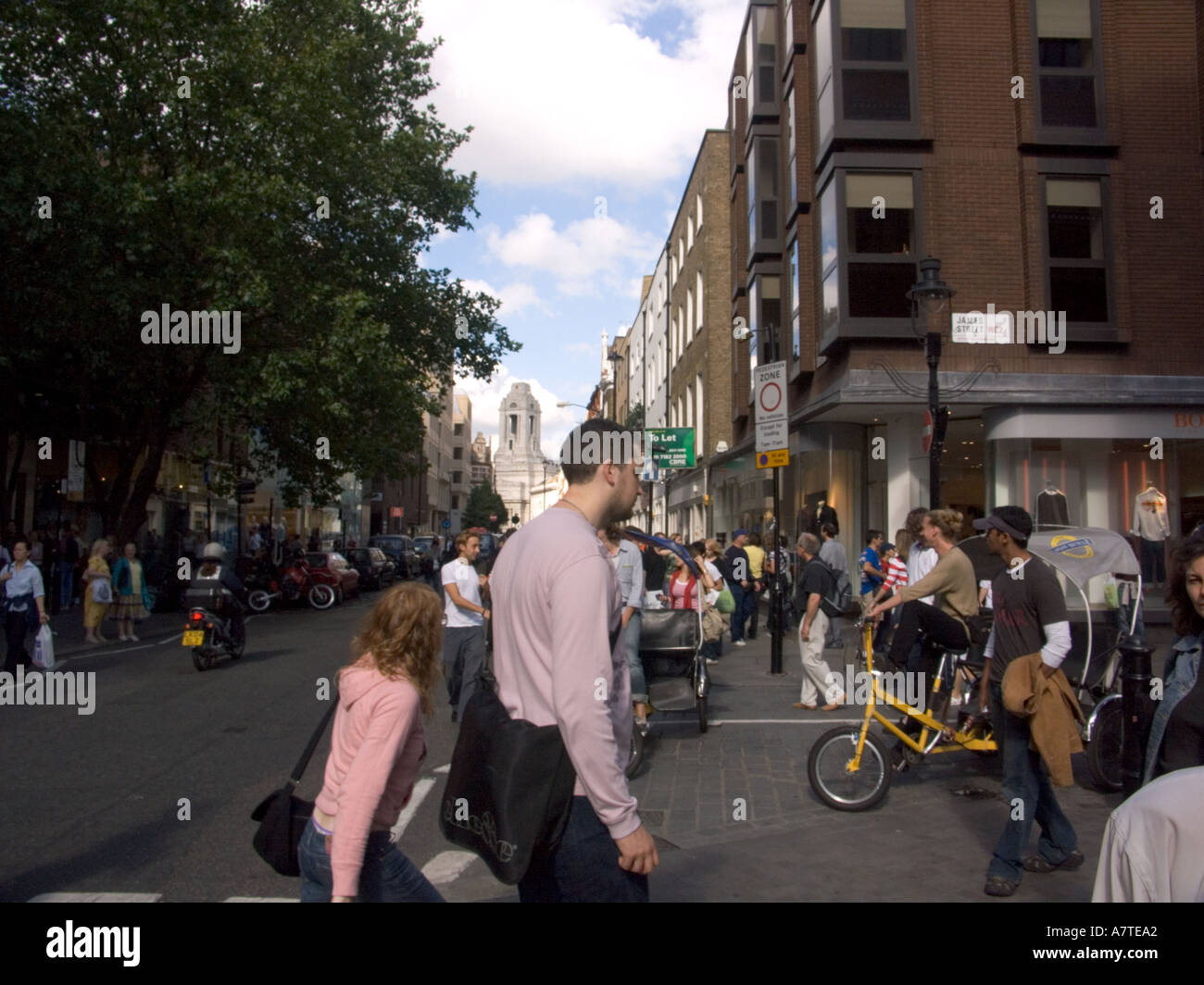 Street scene Crowds and rickshaws London outside Covent Garden Tube Station London WC2 England GB UK commuters tourists Stock Photo