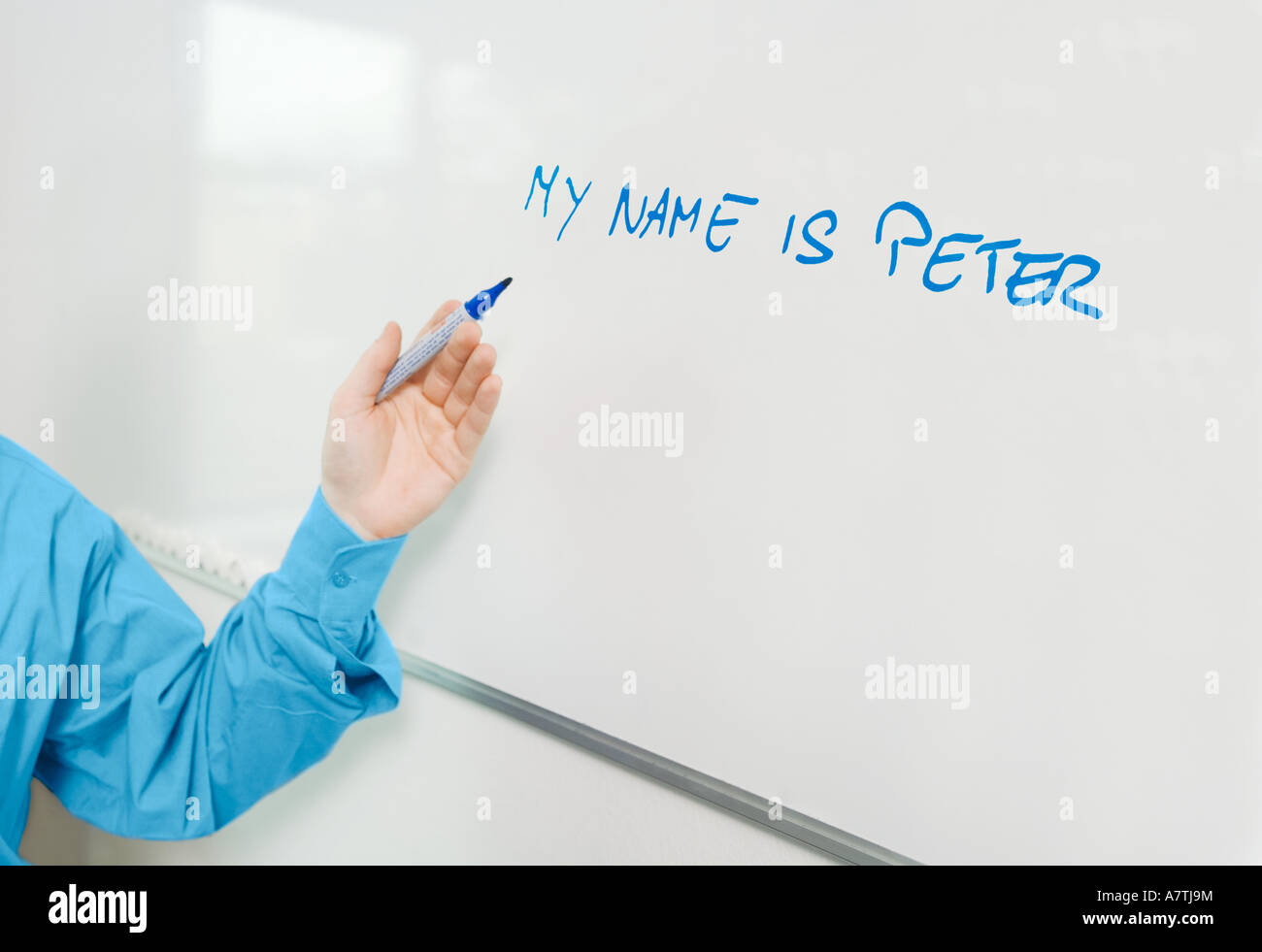 Close-up of man's hand pointing towards whiteboard Stock Photo