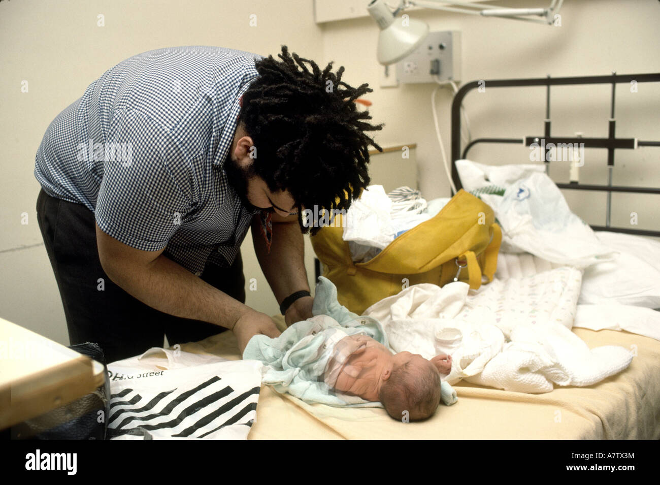 father dressing newborn before leaving hospital Stock Photo Alamy