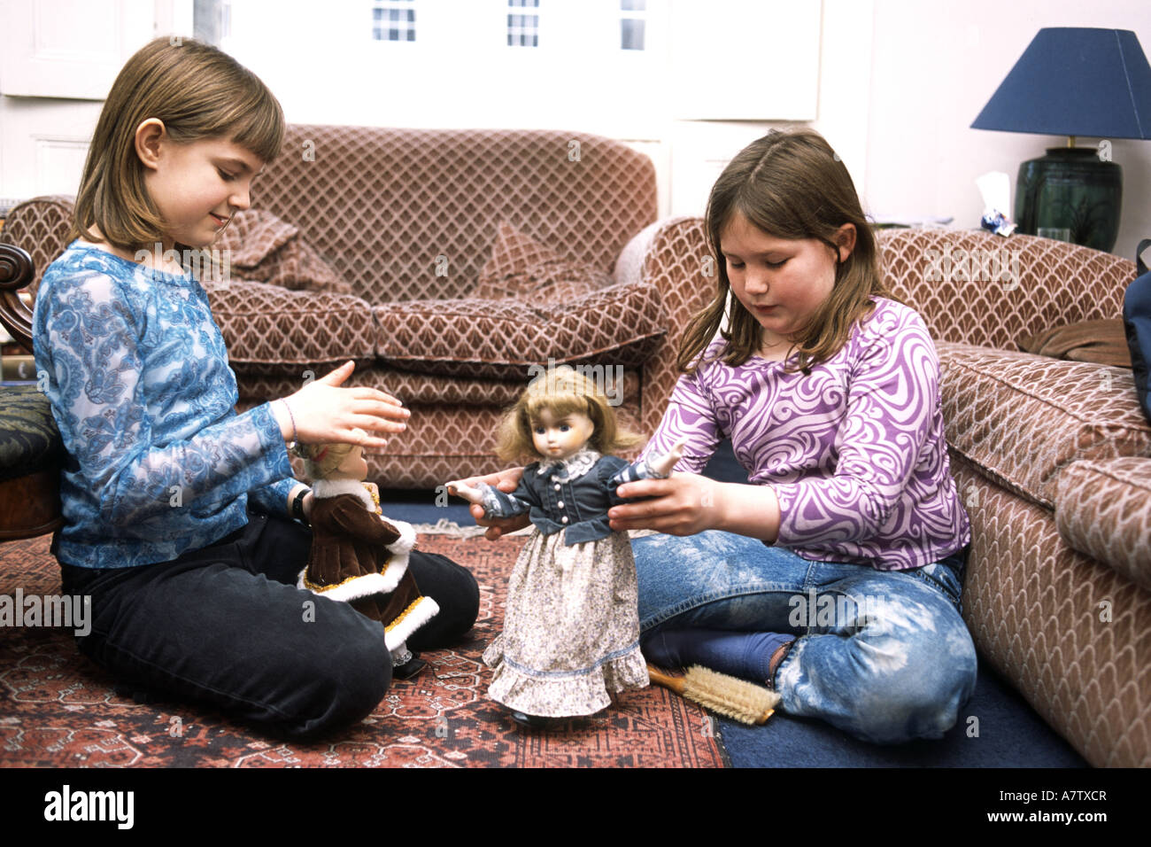young girls playing with dolls Stock Photo
