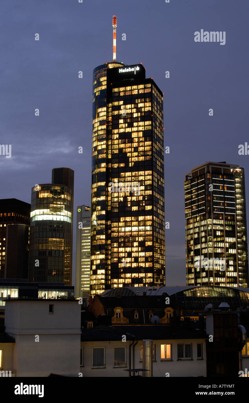 Buildings in city lit up against evening sky, Frankfurt, Germany Stock