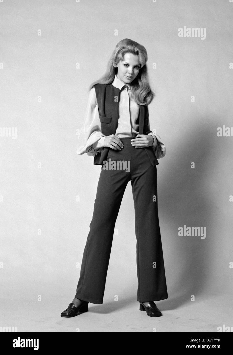 1960s 1970s PORTRAIT WOMAN WITH LONG BLOND HAIR WEARING FLARED PANTSUIT WITH VEST Stock Photo