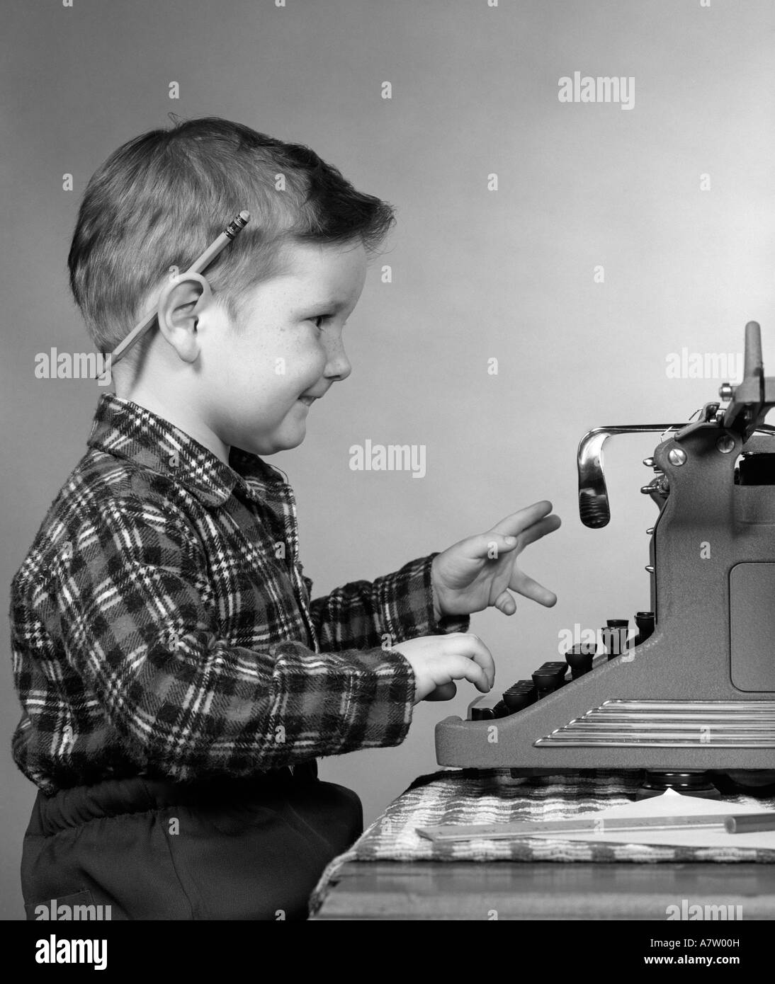 Boy Typing On Old Typewriter Stock Photo - Download Image Now