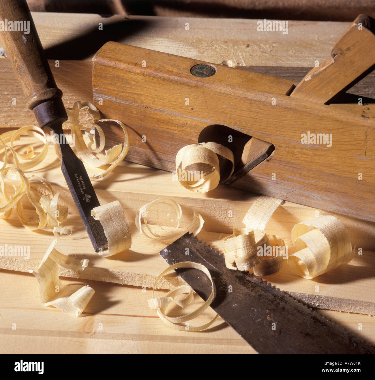 Closeup of chisel and saw with wood shavings Stock Photo Alamy