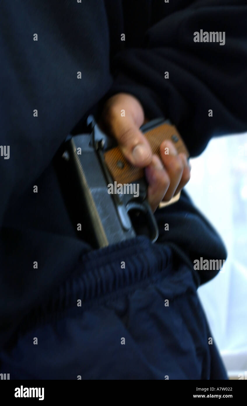a gang member holding a colt automatic pistol gun Stock Photo