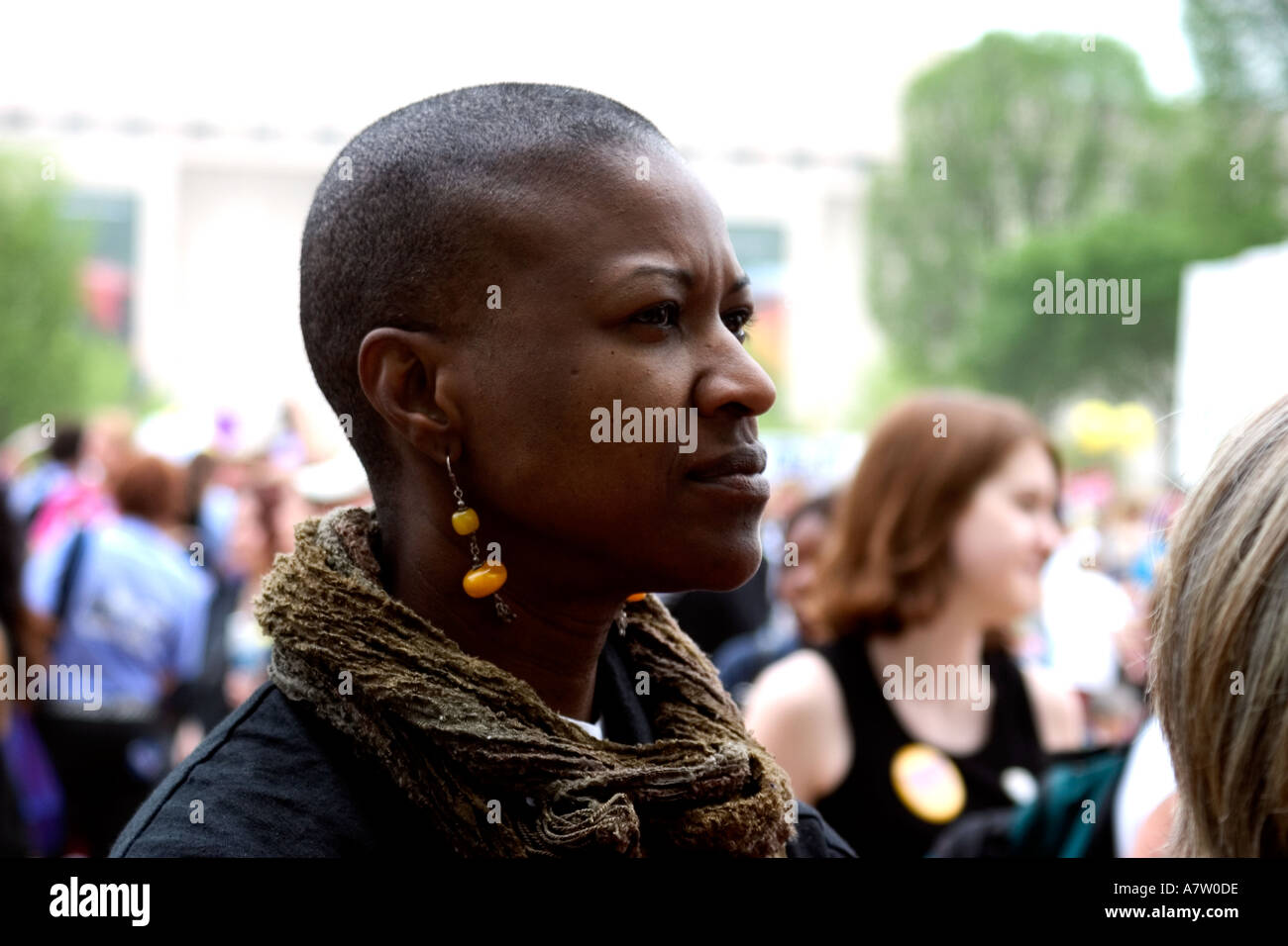 A black woman with a shaved head and amber earrings is seen at the pro choice March on Washington DC April 25 2003 Stock Photo