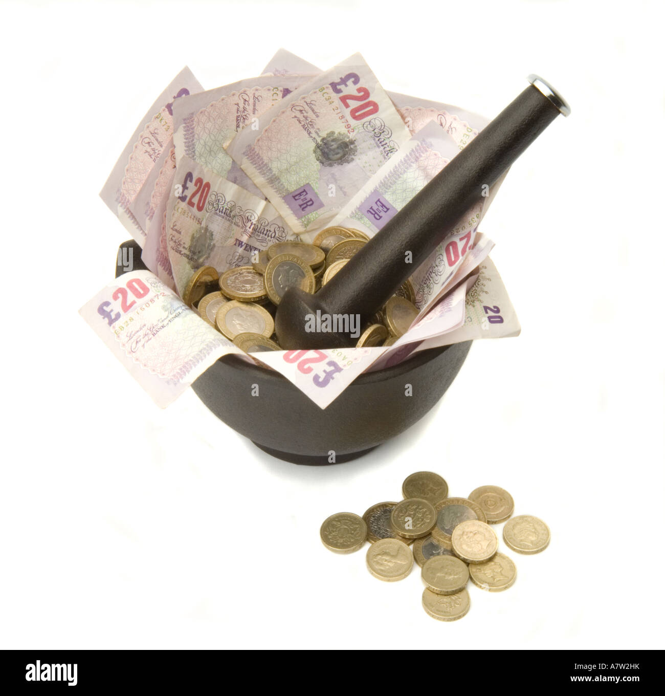 Mortar Pestle Grinding 20 notes with Coins Stock Photo