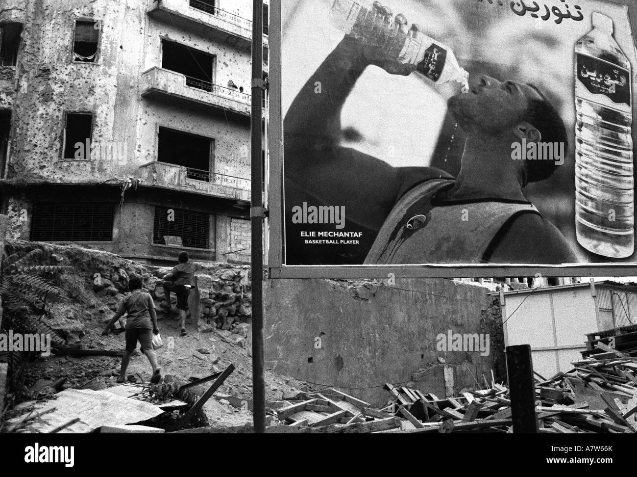 Two boys playing near a derelict building in Beirut damaged during the civil war Stock Photo