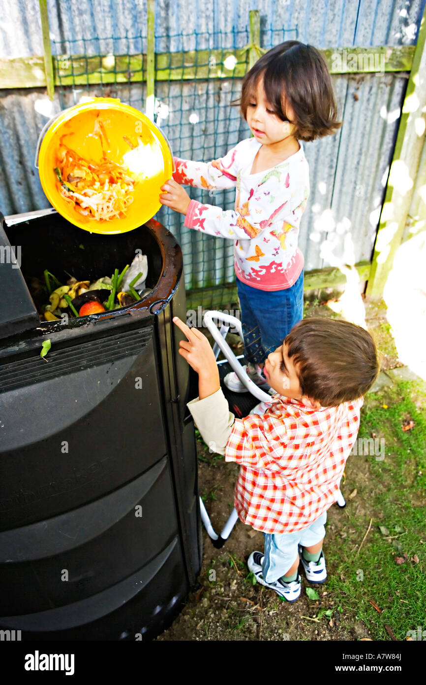 Child puts kitchen waste in a compost bin Stock Photo Alamy