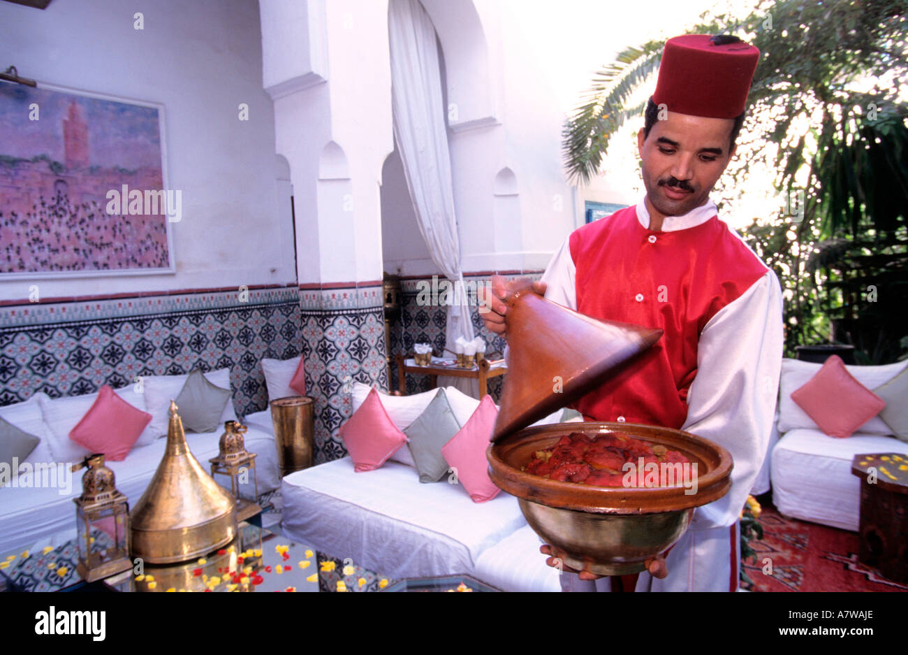 Morocco, Haut Atlas, Marrakesh, a waiter serving a Moroccan food in Dar Marjana restaurant Stock Photo