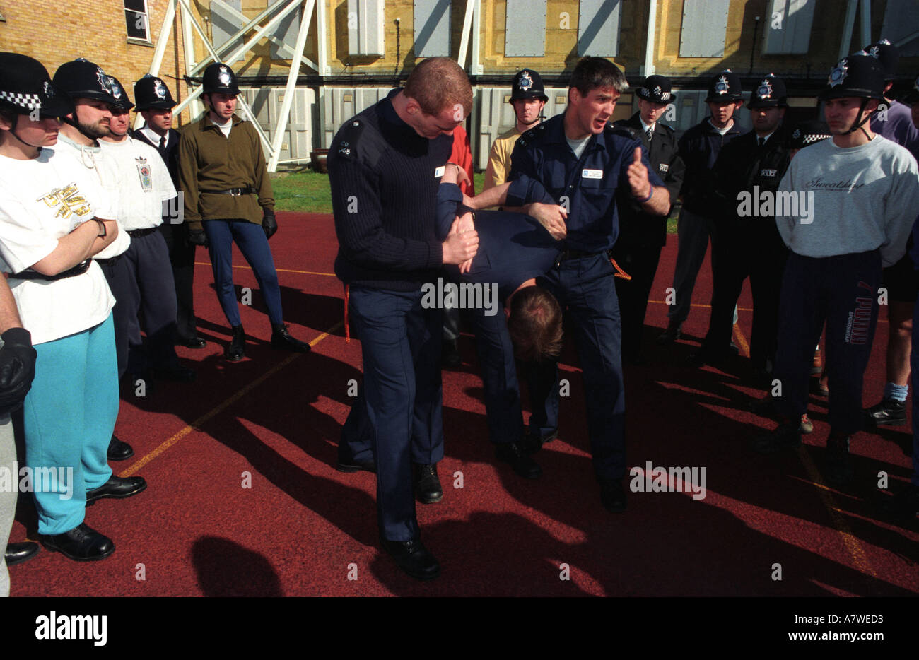 Metropolitan police public order training instructors demonstrating arrest and restraint techniques to fellow officers, London, UK. Stock Photo