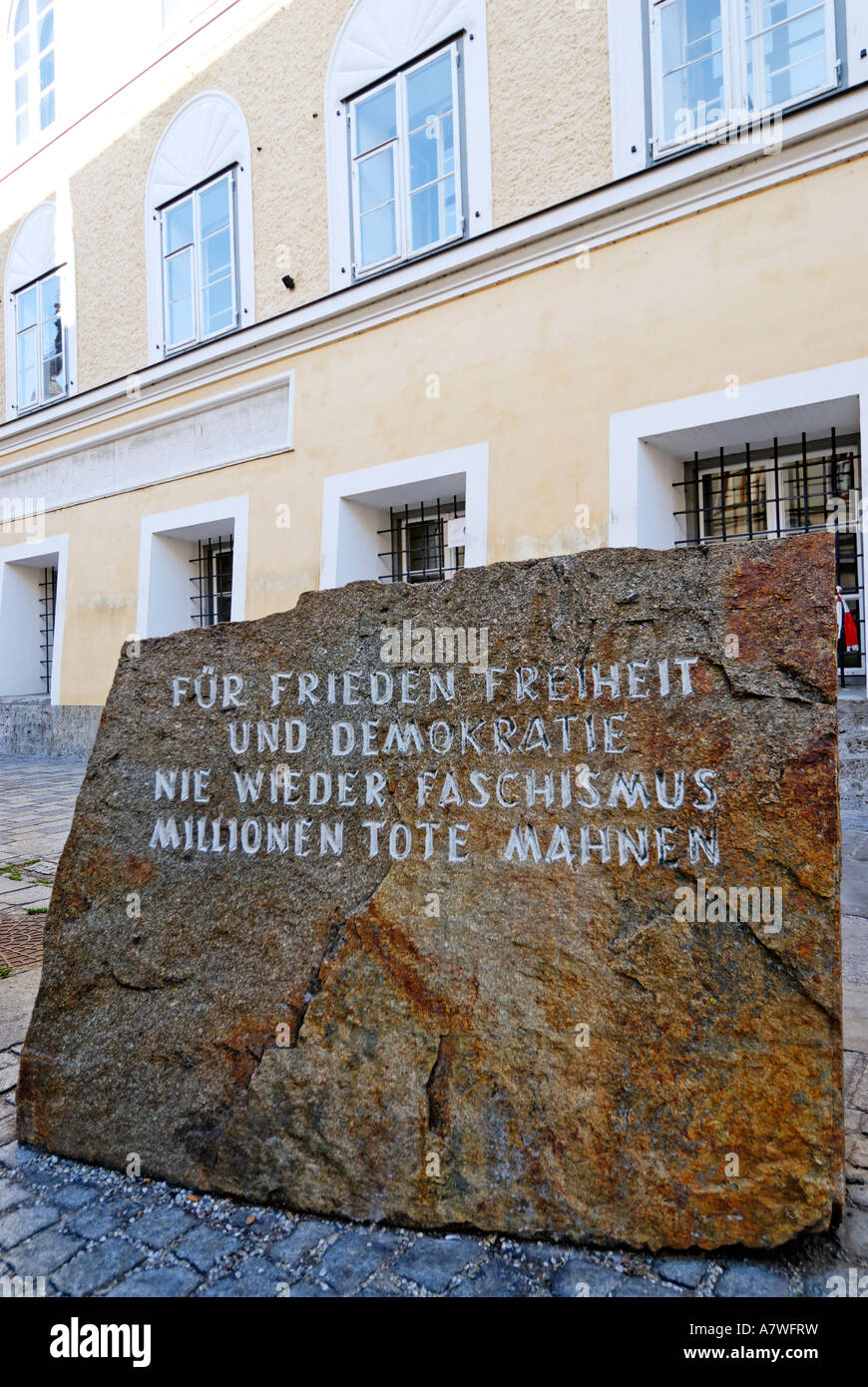 Memorial stone against war and fascism in front of the birth place of Adolf Hitler Braunau upon the river Inn Upper Austria Stock Photo