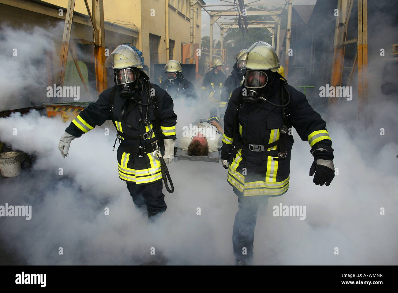 Fire fighters rescue a man during an exercice practice Stock Photo