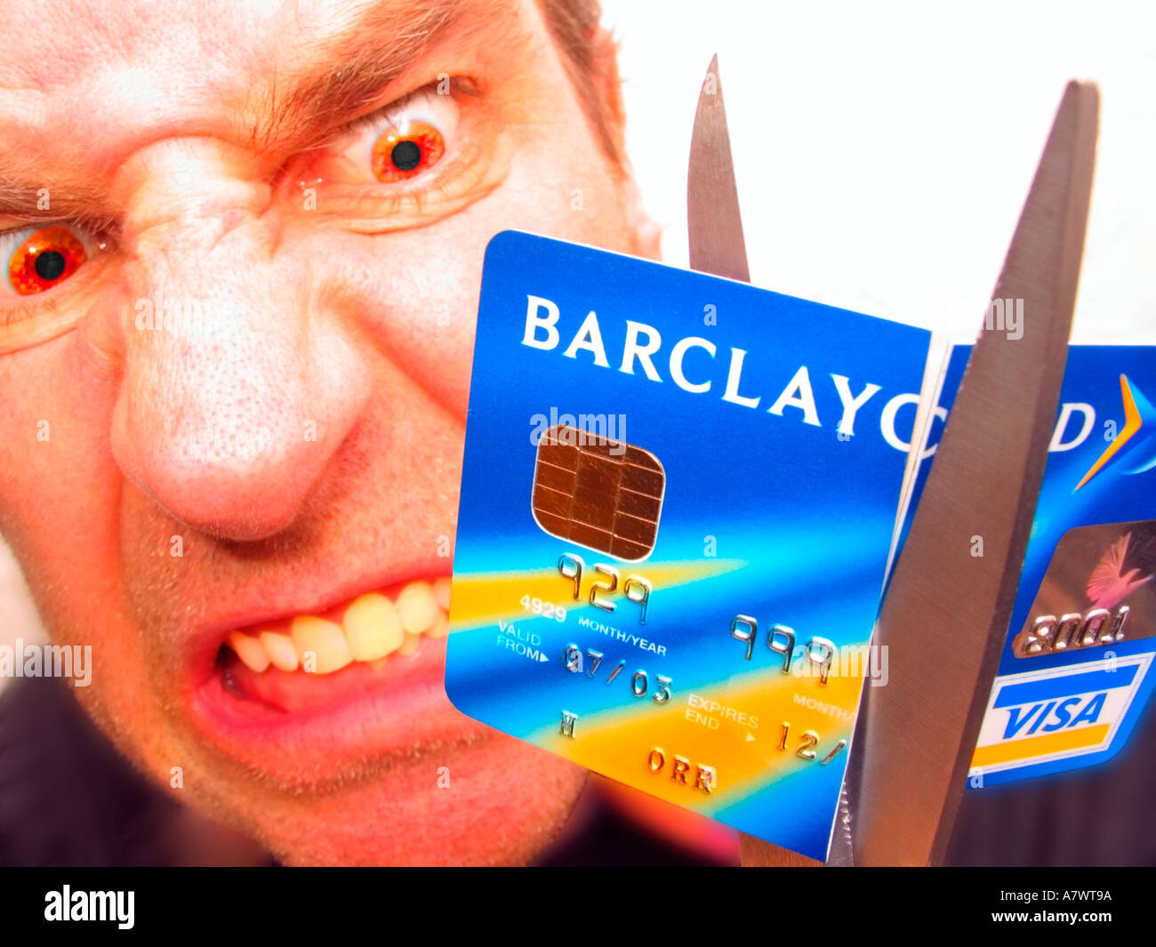 angry person cutting up credit card Stock Photo