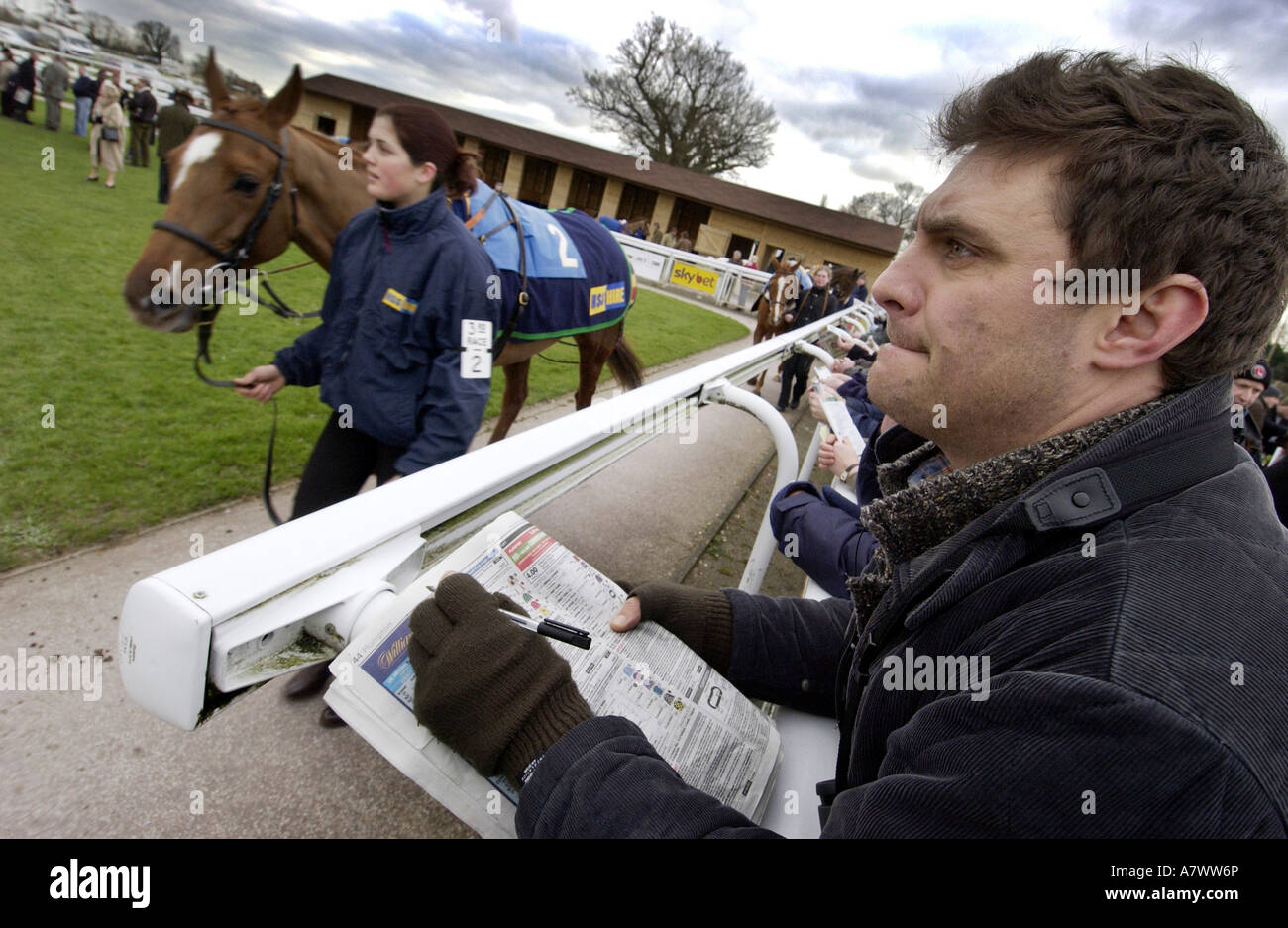 A racegoer with a folded newspaper at the racing page at Plumpton Racecourse, Sussex Stock Photo