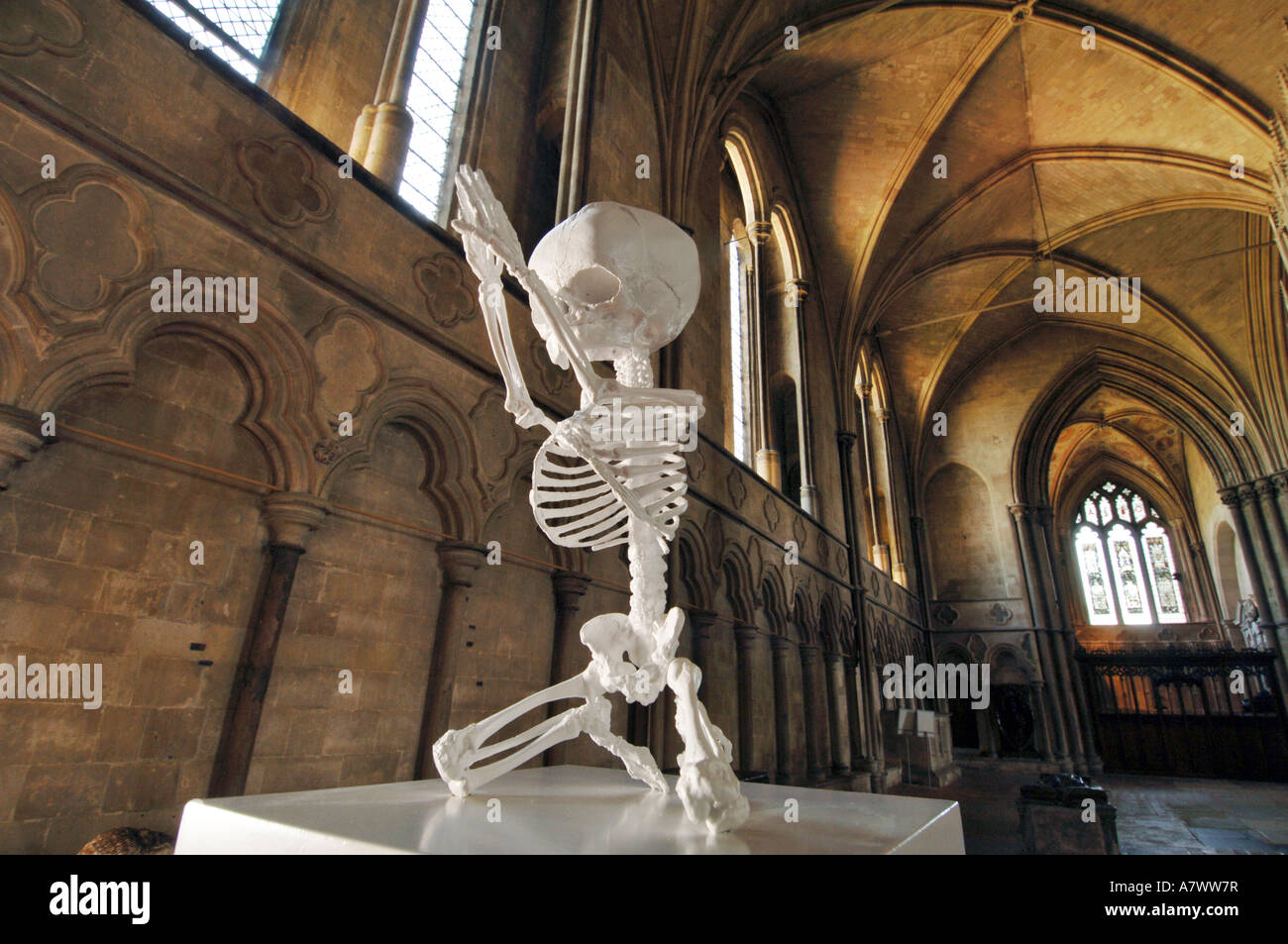 A sculpture of a foetal skeleton with hands lifted in prayer by Mark Quinn at Winchester Cathedral Stock Photo