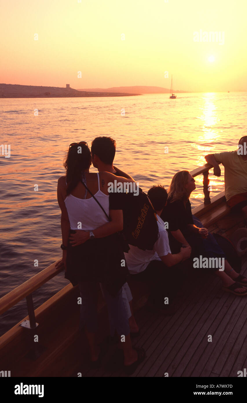 MALTA. A young couple enjoying a sunset cruise along the Maltese coast. Stock Photo