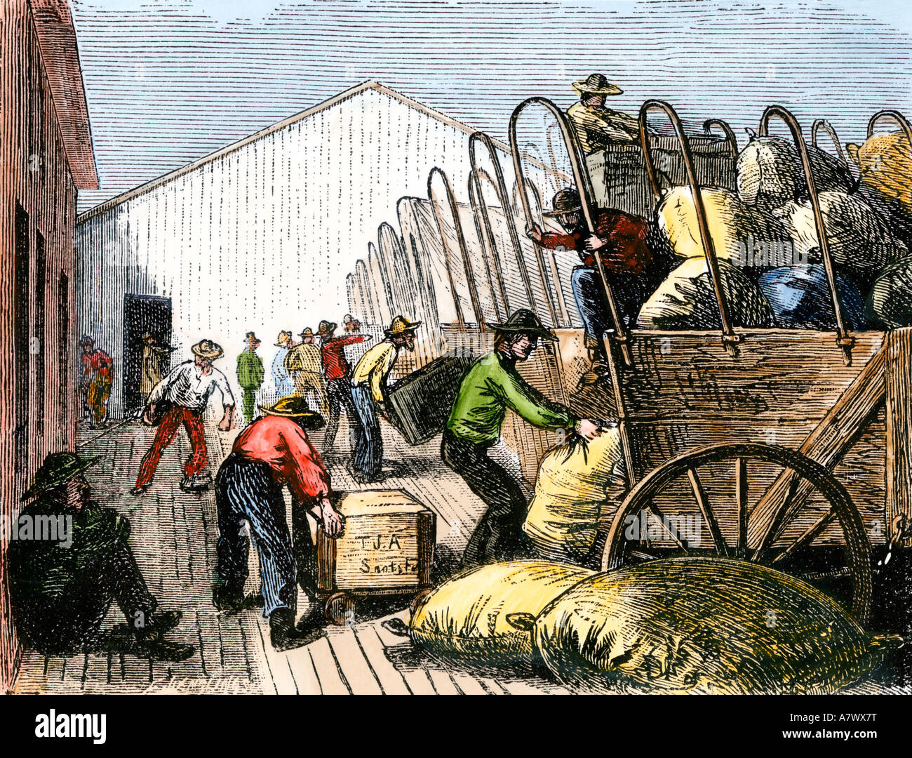 Pioneers loading supplies for covered wagon travel on the Great Plains 1800s. Hand-colored woodcut Stock Photo