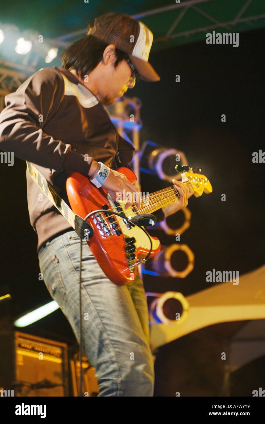 Close Up Portrait Of Bass Player For Chinese Rock Band Neon Performing On Stage Kenting Taiwan China Stock Photo