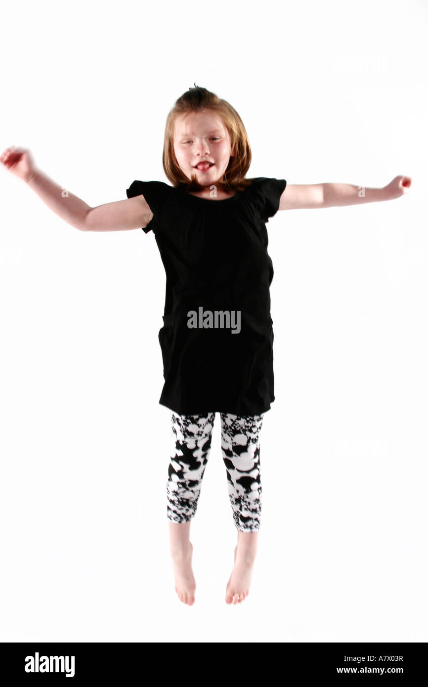 Small girl is captured jumping mid air Stock Photo