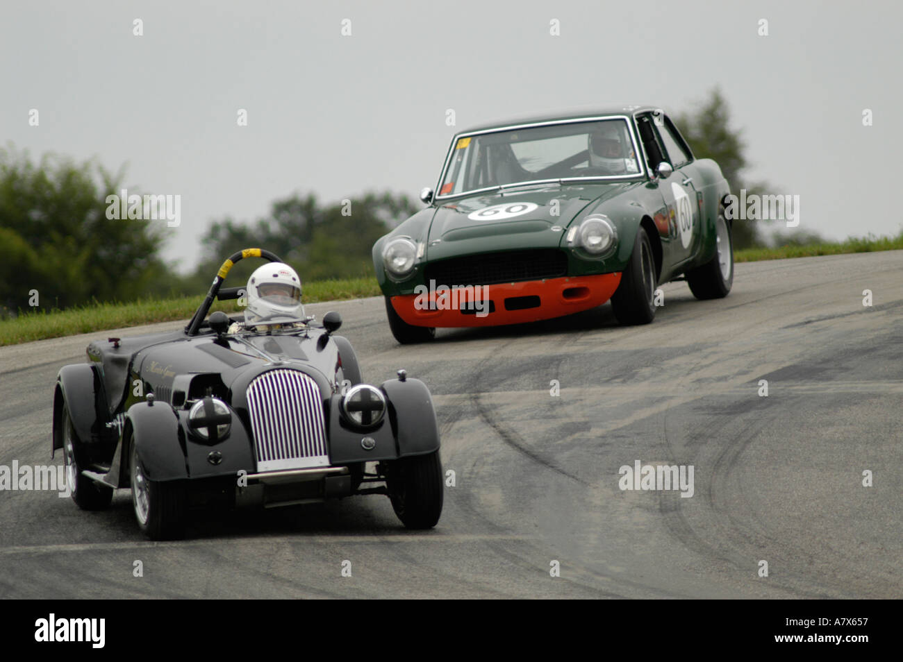 Marilyn Gaunt in her 1956 Morgan Plus 4 followed by Tom Davis in his 1967 MGB GT at the Vintage Grand Prix Au Grattan Stock Photo