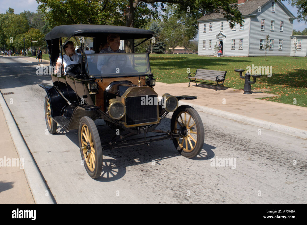 Model T Ford with Giddings Family Home in background at Greenfield Village in Dearborn Michigan Stock Photo
