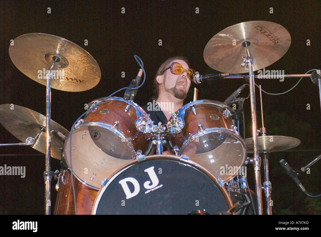 Portrait Of A Drummer Drumming Playing Drums And Singing Performing