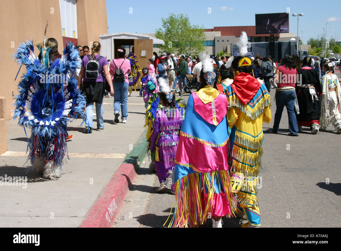 native american women and men dressed for pow wow, gathering of nations