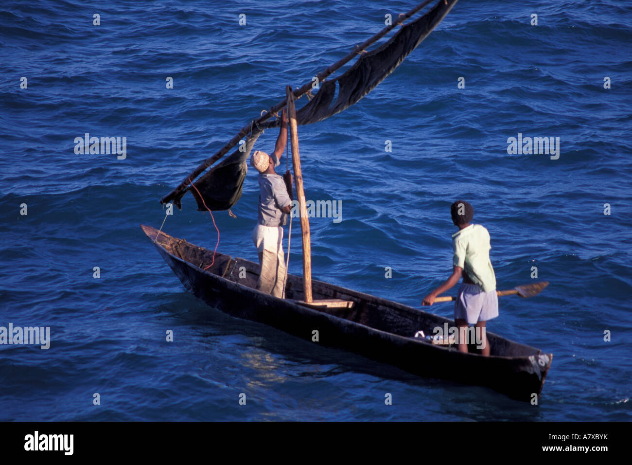 Woman fishing with a traditional woven basket, wooden fishing