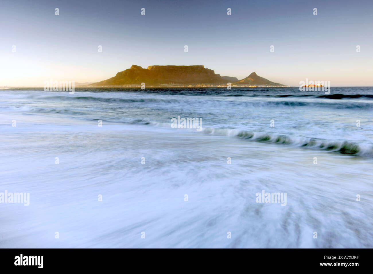 A dawn view of Table Mountain and the city of Cape Town seen across Table bay from Bloubergstrand beach. Stock Photo