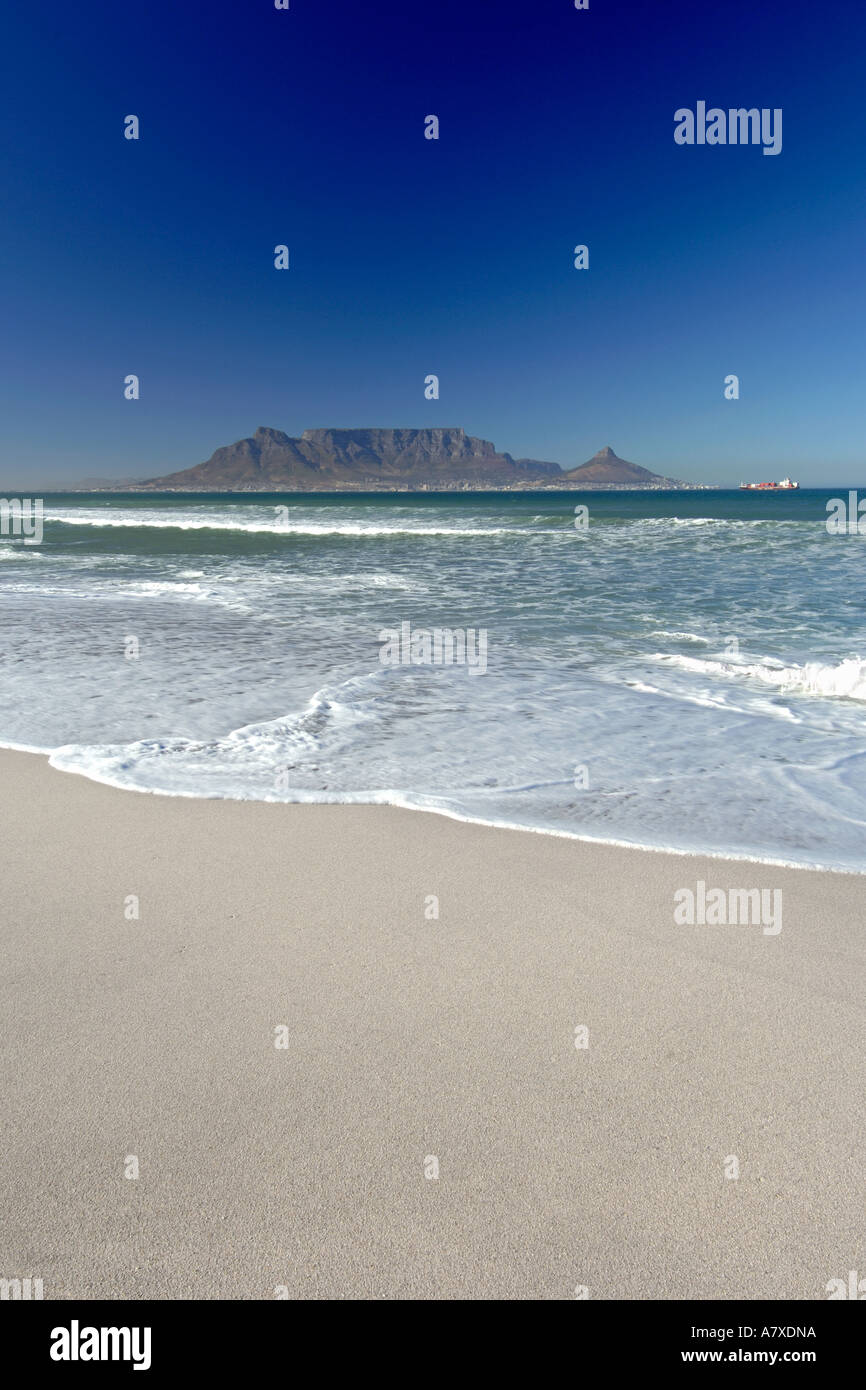 A view of Table Mountain and the city of Cape Town seen across Table bay from Bloubergstrand beach. Stock Photo