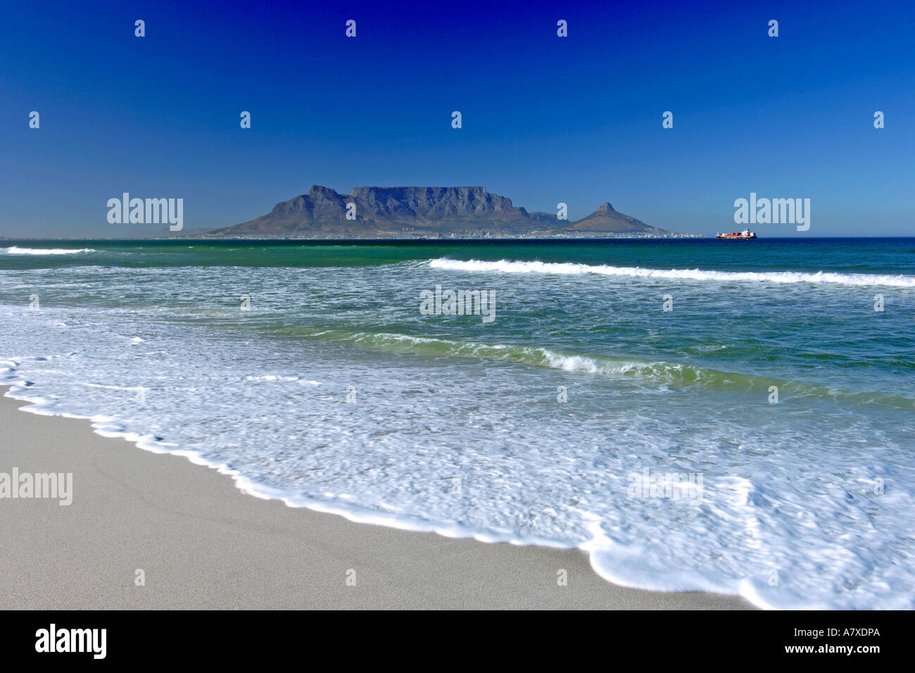 A view of Table Mountain and the city of Cape Town seen across Table bay from Bloubergstrand beach. Stock Photo