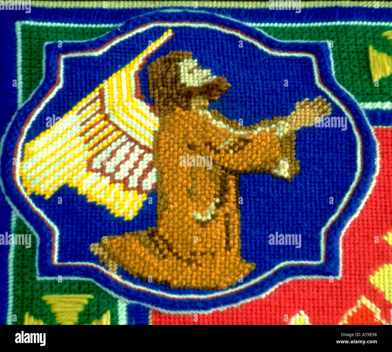 Symbol of St. Matthew a man with wings on needlepoint tapestry. St