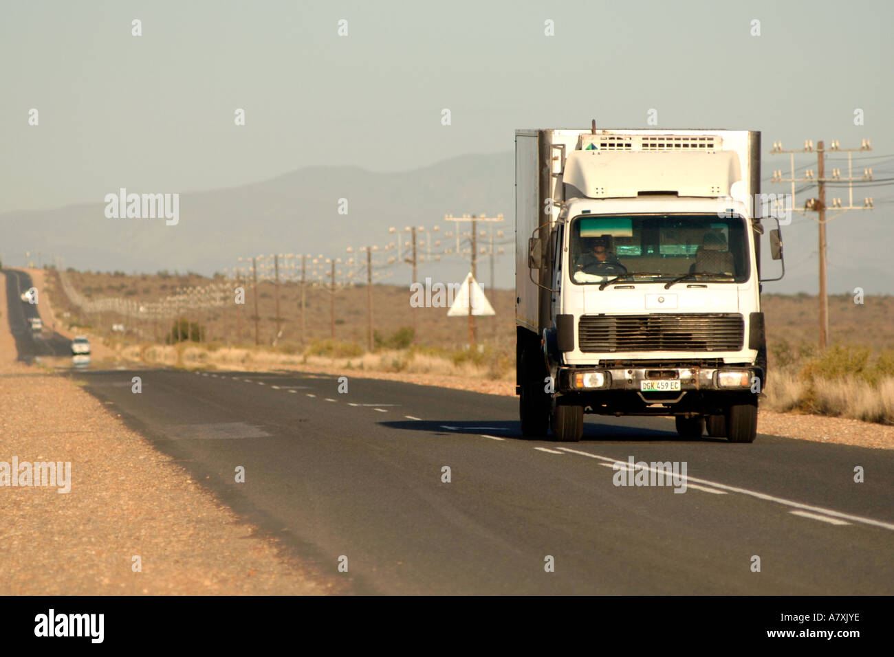 A truck on the R62 road leading to Oudtshoorn in the Karoo region of South Africa's Western Cape Province. Stock Photo