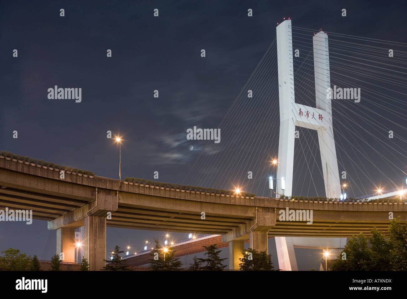 Asia, China, Shanghai, Full moon rises behind clouds above Nanpu Bridge ...