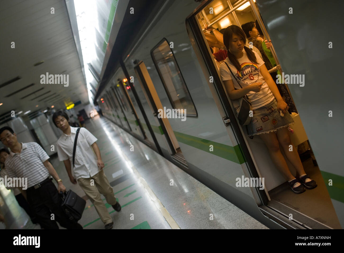 MAN WITH MEGAPHONE PUSH COMMUTERS INTO CROWDED TRAIN SO DOORS WILL CLOSE  RUSH HOUR AT PEOPLE S SQUARE SHANGHAI CHINA Stock Photo - Alamy