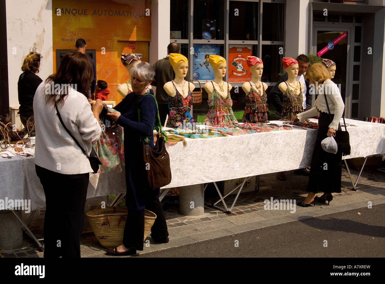 France. Southwest.  Moissac.  Colorful shop models or mannequins shown at the Sunday market Stock Photo