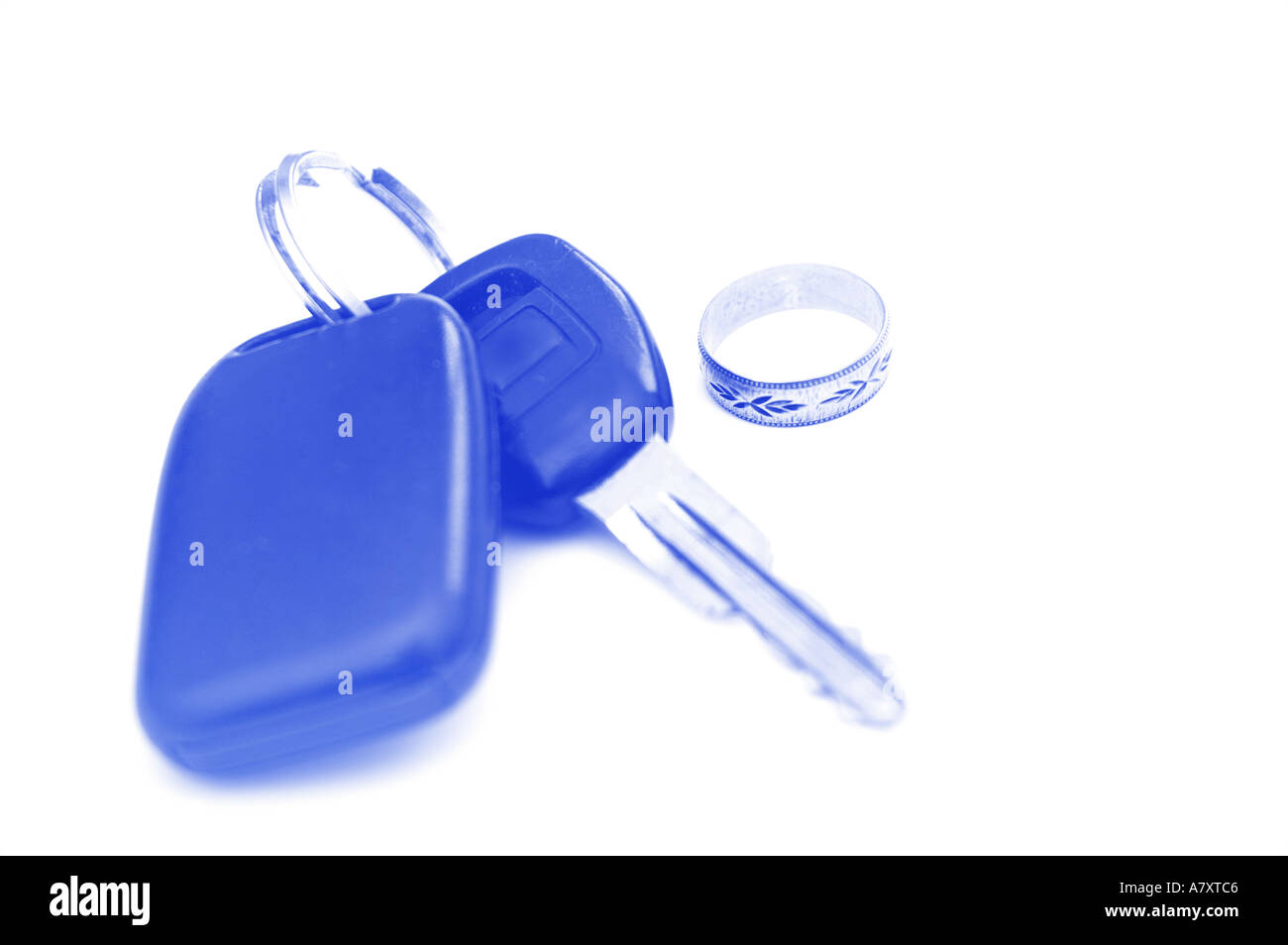Car keys and a wedding ring hint at divorce and leaving home Stock Photo