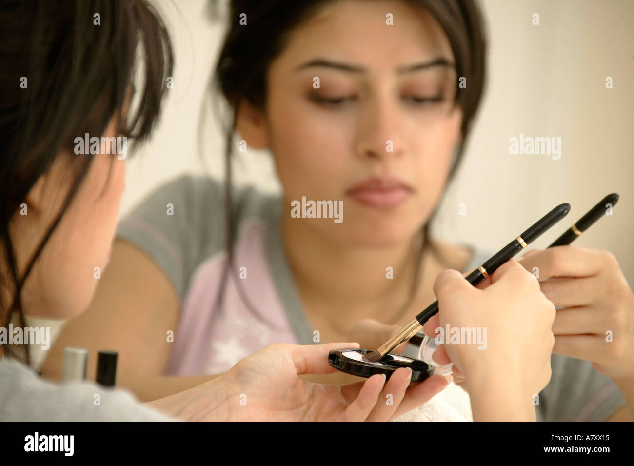 Woman applying make-up Stock Photo