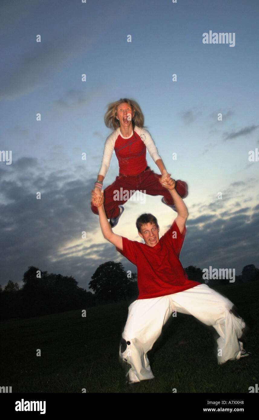 leap-frog playful high-jump high jump leapfrog crazy youthful energetic teenager Stock Photo