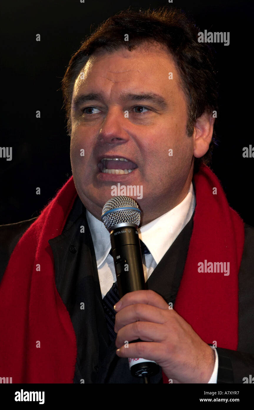 Tv Presenter Eamonn Holmes With Microphone On Stage With Black Coat And Red Scarf Belfast Northern Ireland Tv Presenter Eamonn Holmes With Microphone On Stage With Black Coat And Red Scarf Belfast Northern Ireland