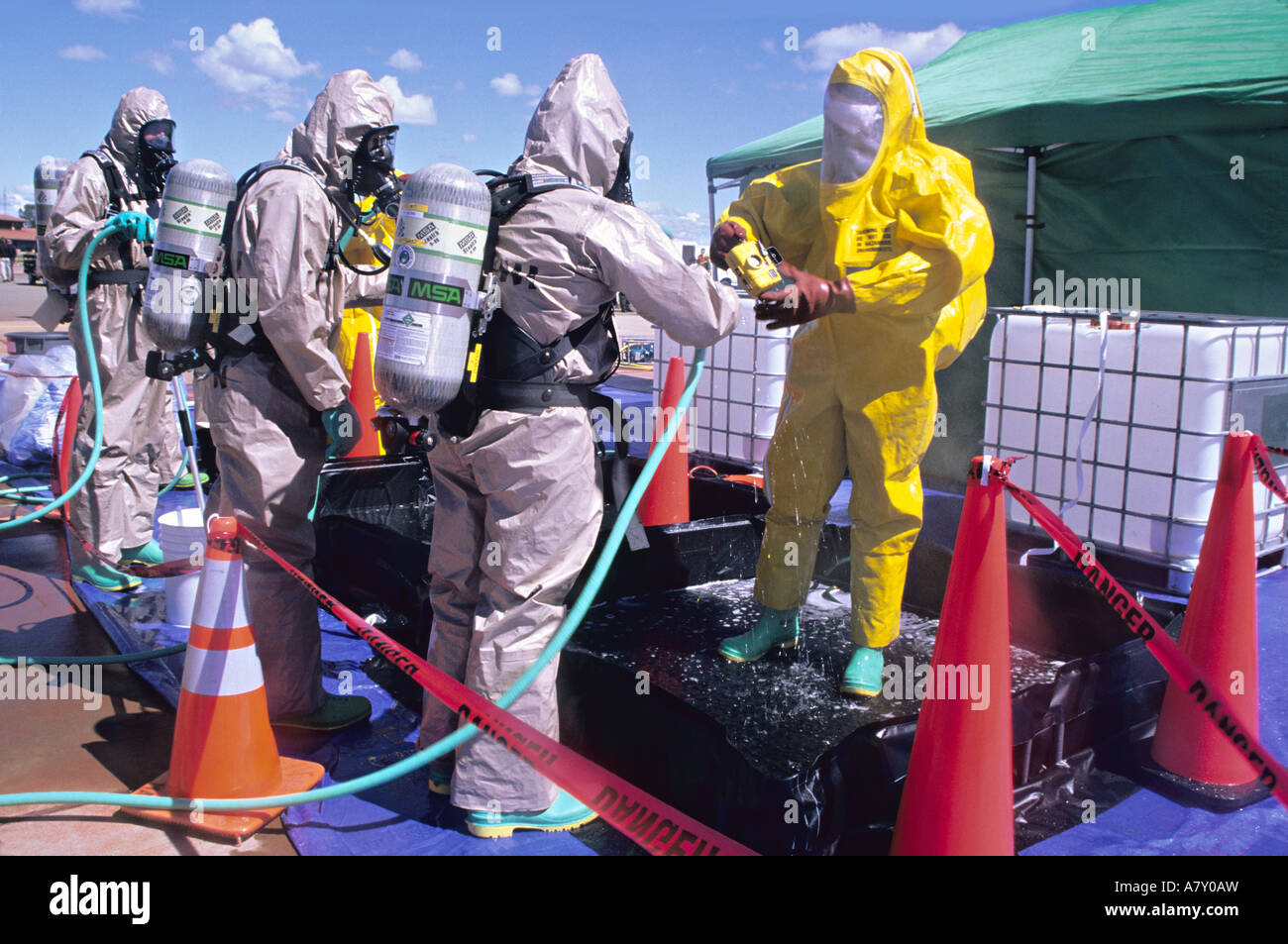 Hazmat team washes member in decontamination line Stock Photo - Alamy