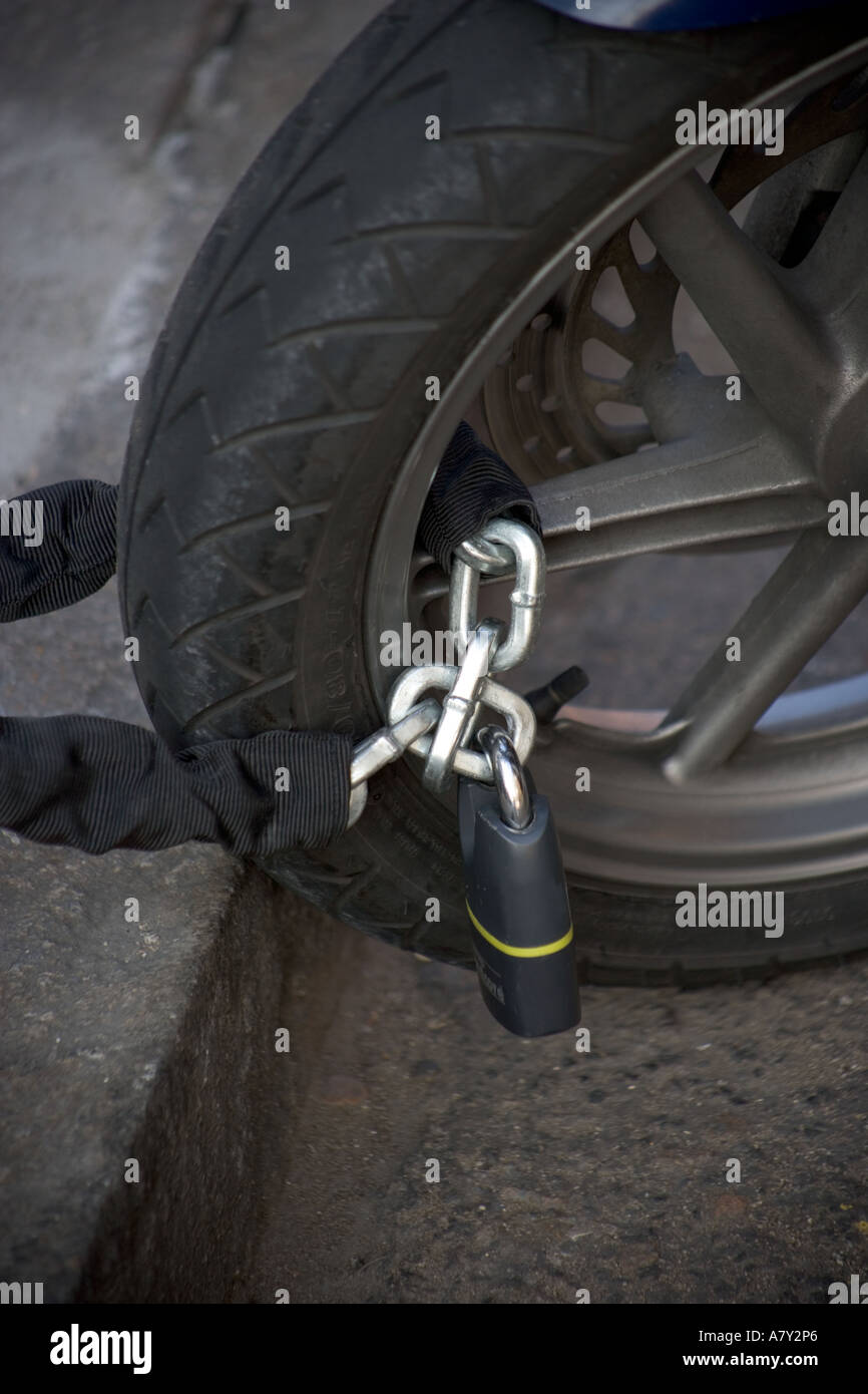 Motorbike Wheel with Chain and Lock Stock Photo Alamy