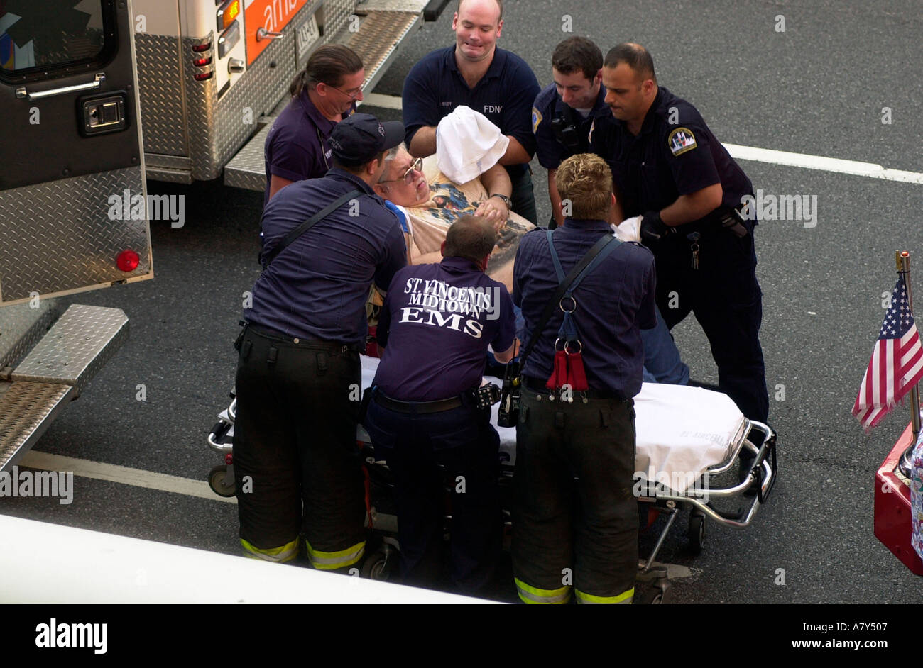 Emergency Medical Workers transfer an obese patient into the ambulance