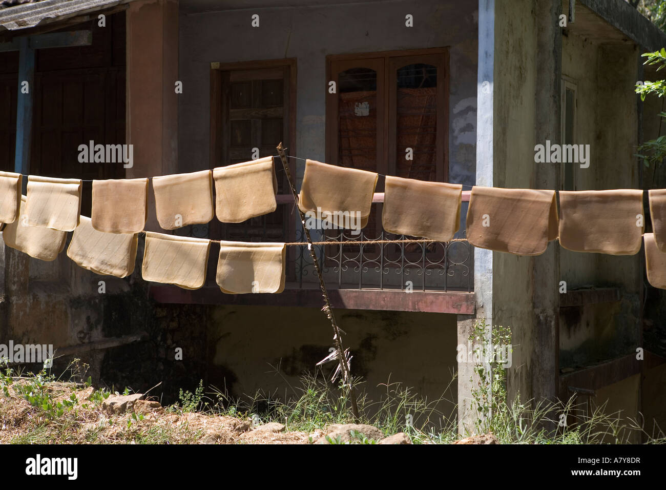 Rubber sheets drying outside a house Stock Photo Alamy