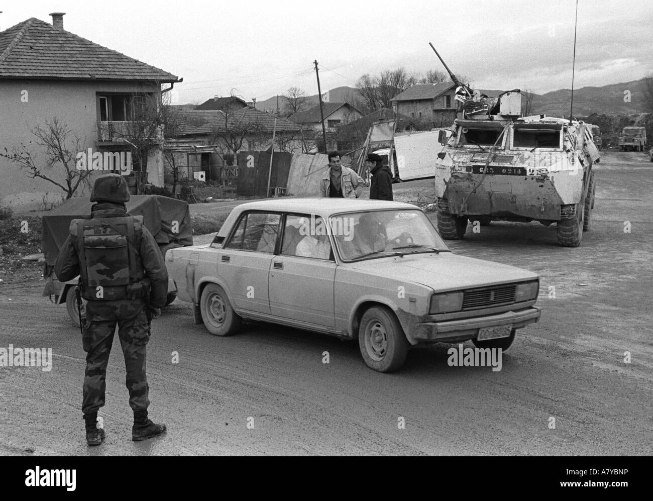 French NATO soldiers are directing traffic on the former frontline of Kasindolska Street. Stock Photo