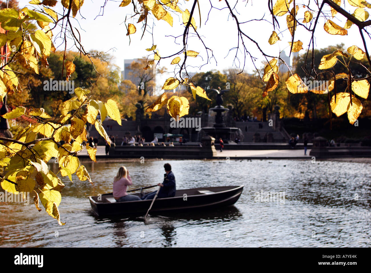 Central Park, New York. Pond and Bethesda Fountain, rowing boat, Fall and golden leaves. Stock Photo